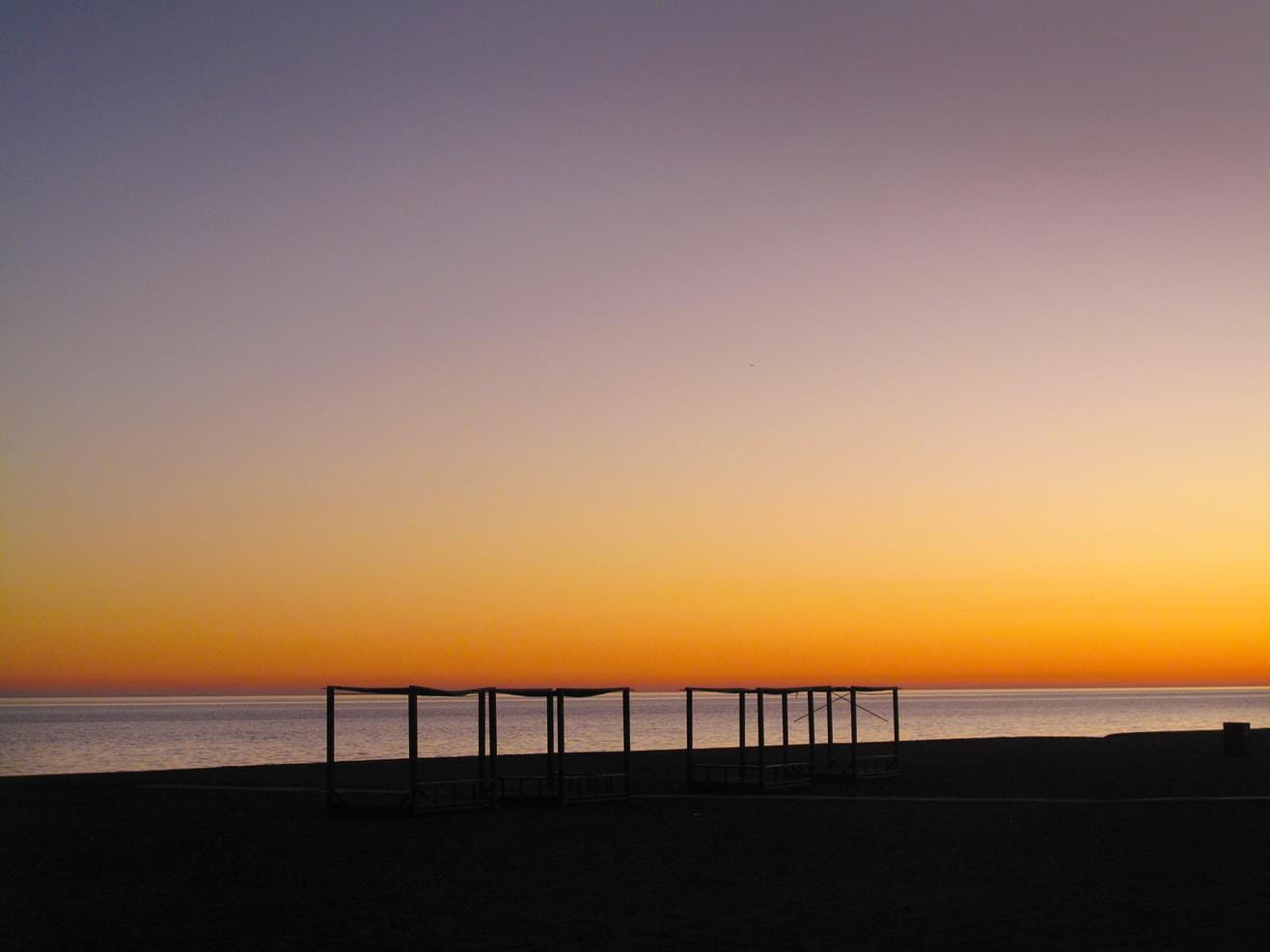 Sea view with a colourful sunset on a beach in Spain